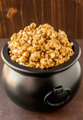 Homemade Caramel Popcorn! With a rich homemade caramel sauce drizzled over fresh popcorn, this caramel corn is sure to bring back childhood memories of carnivals and fairs! | HomemadeHooplah.com