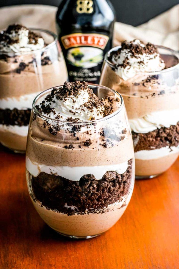 Three glasses full of prepared Baileys cookies and cream parfaits.