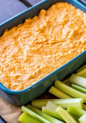 Side view of prepared buffalo chicken dip served with celery.